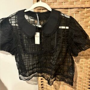 By Anthropologie sheer cropped black top with collar. NWT